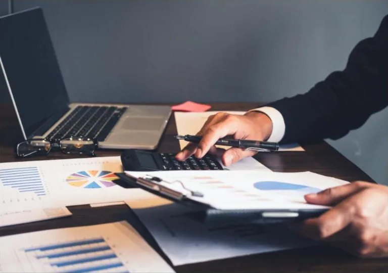Reviewing monthly financial reports and reconciliations